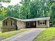Charming home with mature trees, well-maintained lawn, and a paved driveway at 364 Stafford Sw St, Marietta, GA 30064