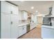 Bright kitchen features white cabinets, modern countertops, stainless steel appliances, and stylish backsplash at 364 Stafford Sw St, Marietta, GA 30064