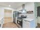 Bright kitchen boasts stainless steel appliances, gas range, ample storage, and modern countertops at 364 Stafford Sw St, Marietta, GA 30064