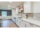 Bright kitchen features white cabinets, modern countertops, stainless steel appliances, and stylish backsplash at 364 Stafford Sw St, Marietta, GA 30064