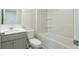 A bathroom featuring a combination tub and shower, toilet, and a vanity with sink and mirror at 2804 Georgia Aster Way Nw, Atlanta, GA 30318