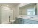 Bathroom featuring a double sink vanity, large mirror, and a glass-enclosed shower stall at 2804 Georgia Aster Way Nw, Atlanta, GA 30318