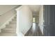 Bright foyer with wood flooring, gray walls, and carpeted staircase at 2804 Georgia Aster Way Nw, Atlanta, GA 30318