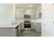 Modern kitchen with grey cabinets, granite countertops, and stainless steel appliances at 2804 Georgia Aster Way Nw, Atlanta, GA 30318