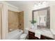 Well-lit bathroom with a granite vanity, framed mirror, and shower/tub combo at 2808 Broughton Se Ln, Atlanta, GA 30339