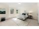 Bedroom with windows, carpeted floors, and a large bed with decorative pillows at 2808 Broughton Se Ln, Atlanta, GA 30339