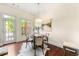 Bright dining area features hardwood floors, decorative lighting, and a door to the patio at 2808 Broughton Se Ln, Atlanta, GA 30339