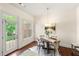 Bright dining room with hardwood floors, a modern chandelier, and glass doors to the patio at 2808 Broughton Se Ln, Atlanta, GA 30339