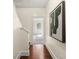 Hallway with wood floors, framed art, and an opening leading to a bedroom space at 2808 Broughton Se Ln, Atlanta, GA 30339