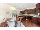 Well-lit eat-in kitchen with dark wood cabinetry, granite countertops, stainless appliances, and a center island at 2808 Broughton Se Ln, Atlanta, GA 30339