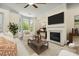 Bright living room with bay windows, fireplace, large TV, and comfortable seating at 2808 Broughton Se Ln, Atlanta, GA 30339