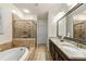 Beautiful main bathroom with dual sinks, a soaking tub, and a glass shower at 2808 Broughton Se Ln, Atlanta, GA 30339