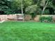 Large green grass backyard with a swing, hammock, privacy fence and mature landscaping at 710 Oxford Crest Ct, Lawrenceville, GA 30043