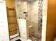 Contemporary bathroom showcases a stone tiled shower with glass partition and a convenient seating area at 710 Oxford Crest Ct, Lawrenceville, GA 30043