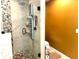 Contemporary bathroom showcases a stone tiled shower with glass partition and modern fixtures at 710 Oxford Crest Ct, Lawrenceville, GA 30043