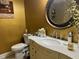 Elegant bathroom with a marble countertop, vanity, and oval mirror at 710 Oxford Crest Ct, Lawrenceville, GA 30043