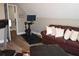 Comfortable bonus room featuring workout equipment, a leather sofa, and a view of the backyard at 710 Oxford Crest Ct, Lawrenceville, GA 30043