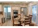 Charming dining area with stainless appliances, brick wall accent, and a sliding glass door to the outside at 710 Oxford Crest Ct, Lawrenceville, GA 30043