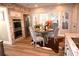 Bright dining area featuring stainless steel appliances, brick accent wall, and a sliding glass door to the outside at 710 Oxford Crest Ct, Lawrenceville, GA 30043