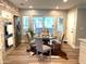 Eat-in kitchen with stainless steel appliances, brick accent wall, and a dining table with upholstered chairs at 710 Oxford Crest Ct, Lawrenceville, GA 30043