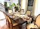 Formal dining room featuring an elegant dining table set for a dinner party with formal place settings at 710 Oxford Crest Ct, Lawrenceville, GA 30043