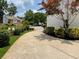 Paved driveway lined with manicured bushes and trees leads to a well-kept home at 710 Oxford Crest Ct, Lawrenceville, GA 30043
