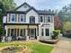 Beautiful two-story home with a covered porch, shutters, and brick accents at 710 Oxford Crest Ct, Lawrenceville, GA 30043