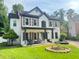 Charming two-story home with a covered porch, shutters, and well-maintained lawn at 710 Oxford Crest Ct, Lawrenceville, GA 30043