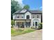 Inviting two-story home with covered front porch and mature landscaping in a residential neighborhood at 710 Oxford Crest Ct, Lawrenceville, GA 30043