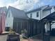 View of the home's screened in porch, deck, grill, and air conditioner system at 710 Oxford Crest Ct, Lawrenceville, GA 30043