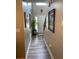 Long, neutral-toned hallway featuring wood-look flooring and leading to the front door and staircase at 710 Oxford Crest Ct, Lawrenceville, GA 30043