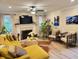 Bright living room featuring a yellow sectional sofa, fireplace, and decorative decor at 710 Oxford Crest Ct, Lawrenceville, GA 30043