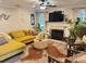 Comfortable living room showcases a yellow sectional sofa, fireplace, and decorative elements at 710 Oxford Crest Ct, Lawrenceville, GA 30043