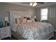Comfortable bedroom showcasing a bed with white linens and ample natural light from the windows at 710 Oxford Crest Ct, Lawrenceville, GA 30043