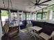 Relaxing screened porch with hot tub, ceiling fan, and comfortable seating area to enjoy time outdoors at 710 Oxford Crest Ct, Lawrenceville, GA 30043