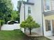 Landscaped side yard with healthy trees and well-maintained white fencing at 710 Oxford Crest Ct, Lawrenceville, GA 30043