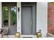 Close up of the entryway featuring a modern door, brick accents, and stylish planters at 1251 Chelsea Nw Cir # 30, Atlanta, GA 30318