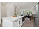 Bright, open-concept kitchen featuring a white island, modern appliances, and natural light at 1251 Chelsea Nw Cir # 30, Atlanta, GA 30318