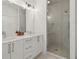 Modern bathroom featuring double sinks with white countertops and a glass-enclosed shower at 1251 Chelsea Nw Cir, Atlanta, GA 30318