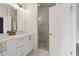 Modern bathroom featuring double sinks with white countertops and a glass-enclosed shower at 1251 Chelsea Nw Cir, Atlanta, GA 30318
