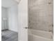 Bathroom with a tub and white marble tile at 1251 Chelsea Nw Cir, Atlanta, GA 30318