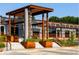 Beautiful building entrance with steel pergolas, lush green planters, and easy access stairs in a commercial location at 1251 Chelsea Nw Cir, Atlanta, GA 30318