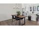 Contemporary dining space open to kitchen, featuring a wood table, modern light fixture, and sleek flooring at 1251 Chelsea Nw Cir, Atlanta, GA 30318
