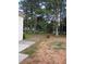 Large grassy backyard with mature trees, partially fenced, offering privacy at 2775 Emerald Springs Dr, Lawrenceville, GA 30045