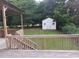 View of the shed and grassy backyard from the wooden deck at 2775 Emerald Springs Dr, Lawrenceville, GA 30045