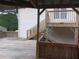 Outdoor deck with wooden railing, steps, and partial roof structure at 2775 Emerald Springs Dr, Lawrenceville, GA 30045