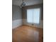 Bright dining room with updated light fixture, hardwood floors, and large window at 2775 Emerald Springs Dr, Lawrenceville, GA 30045