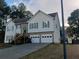 Traditional two-story home boasts a two-car garage, complemented by a mix of siding and brick exterior at 2775 Emerald Springs Dr, Lawrenceville, GA 30045