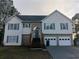Traditional two-story home boasts a two-car garage, complemented by a mix of siding and brick exterior at 2775 Emerald Springs Dr, Lawrenceville, GA 30045