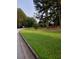 Residential street view, showcasing the well-maintained lawn and mature trees surrounding the property at 2775 Emerald Springs Dr, Lawrenceville, GA 30045
